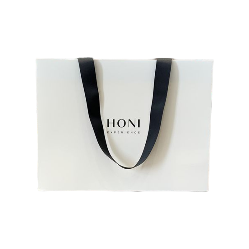 Le cadeau de luxe de mode fait sur commande met en sac le sac d'emballage de courses de sac de papier blanc pour des vêtements