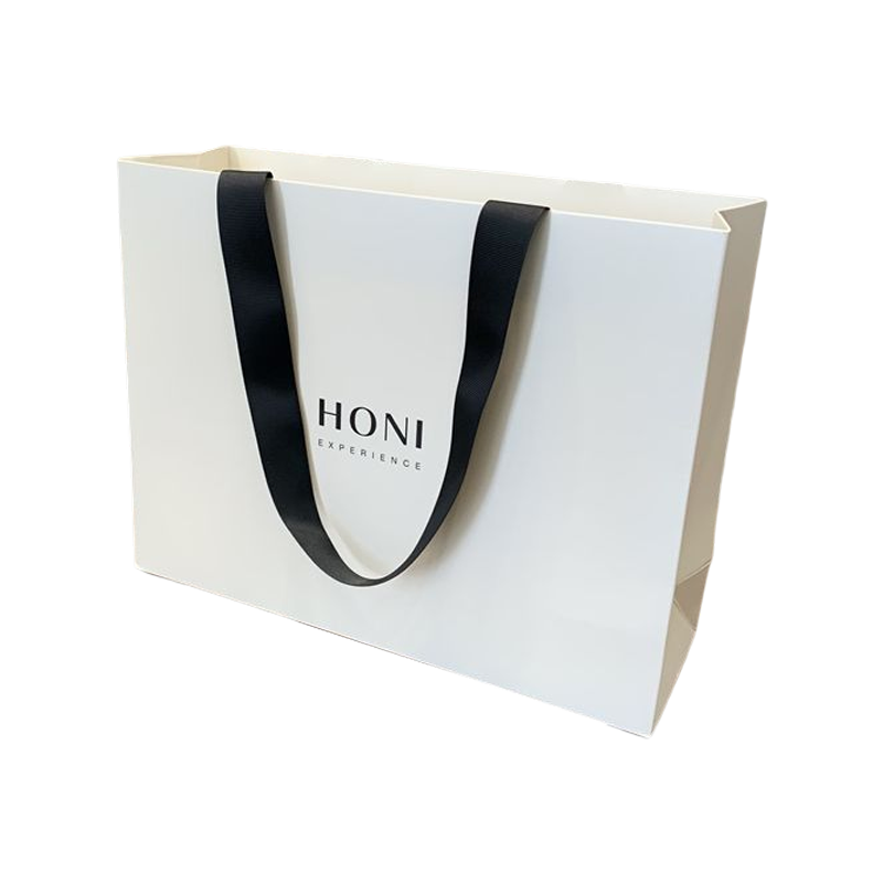 Le cadeau de luxe de mode fait sur commande met en sac le sac d'emballage de courses de sac de papier blanc pour des vêtements