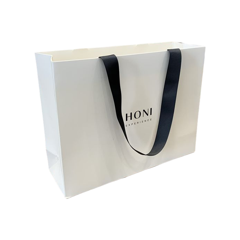 Le cadeau de luxe de mode fait sur commande met en sac le sac d'emballage de courses de sac de papier blanc pour des vêtements